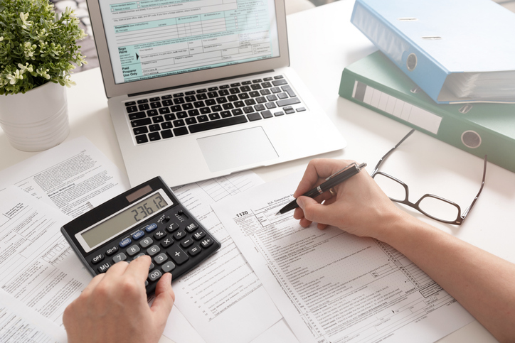 Closeup of a person calculating their taxes.