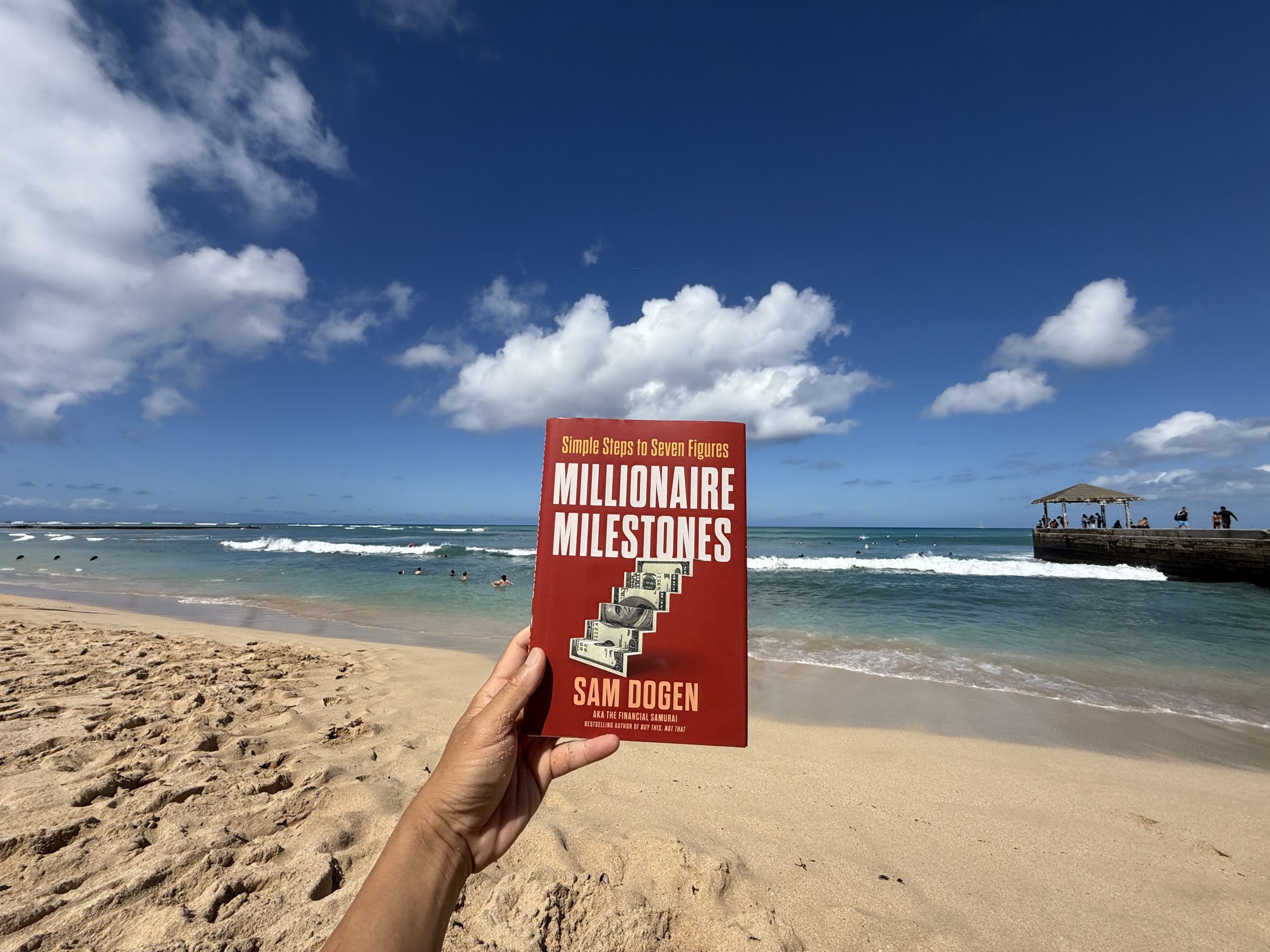 Millionaire Milestones book at the beach