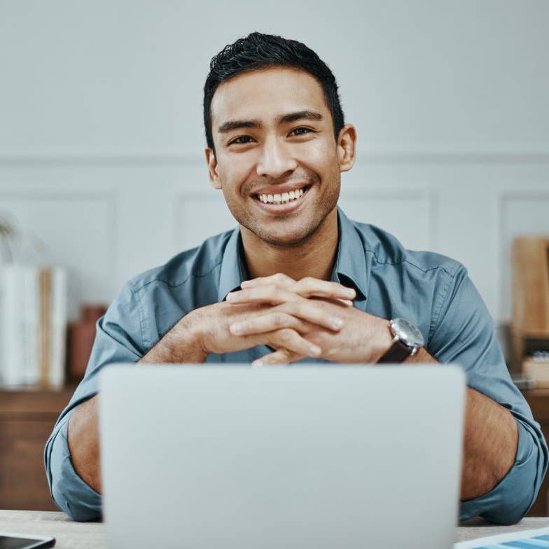 Shot of a young businessman using a laptop in a modern office